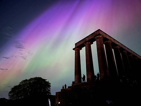 This handout photo taken and released by Jacob Anderson shows the northern lights or aurora borealis during a solar storm over the National Monument of Scotland in Edinburgh on May 10, 2024. The most powerful solar storm in more than two decades struck Earth on May 10, triggering spectacular celestial light shows in skies from Tasmania to Britain — and threatening possible disruptions to satellites and power grids as it persists into the weekend.