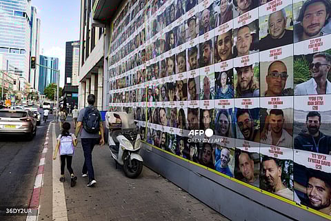 (FILE PHOTO) People walk past posters of Israelis held hostage by Palestinian militants in Gaza since the October 7 attacks, in Tel Aviv on August 11, 2024, amid the ongoing conflict in the Gaza Strip between Israel and the militant Hamas movement.