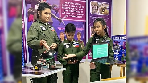 GRADE 6 students Anne Margarette Inton, Dru Triguero and Zyrene Tantay of the Special Education for the Gifted (SPED-G) demonstrate their entry that won them third place in the Future Innovators Category of the Philippine Robotics Olympiad at the Ayala Malls in Trinoma, Quezon City .