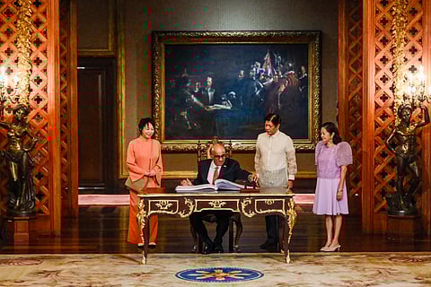 Signed and sealed Singaporean President Tharman Shanmugaratnam signs the guest book at Malacañang Palace as President Ferdinand Romualdez Marcos Jr. and First Lady Liza Araneta-Marcos look on prior to their one-on-one discussion of matters affecting the two countries.