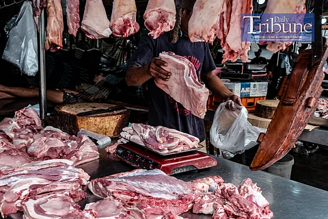 A MEAT vendor chops a pork belly upon order on August 18, 2024. The spread of African Swine Fever (ASF) in the Philippines has led to panic among hog raisers, prompting some to sell infected pigs to traders, further worsening the situation. The Bureau of Animal Industry (BAI) has intercepted several trucks carrying pigs from ASF-hit areas, and the Department of Agriculture (DA) suspects that these traders are a major source of the virus's spread. The government is set to start vaccinating pigs soon to control the outbreak, though concerns remain about the limited availability and effectiveness of vaccines. If the situation deteriorates, the government may consider importing pigs to address potential shortages. PHOTO BY YUMMIE DINGDING