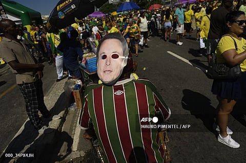 A supporter of former Brazilian President Jair Bolsonaro wears a mask depicting tech tycoon Elon Musk during a demonstration at Copacabana Beach in Rio de Janeiro, Brazil, on April 21, 2024. Brazil's former president Jair Bolsonaro held a rally with supporters in Rio de Janeiro on Sunday in defense of freedom of expression, which he says is under threat in the country, as tech tycoon Elon Musk faces a legal showdown there over claims of censorship and disinformation.