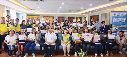 Iloilo City vendors display their certificates after successfully completing the financial literacy training program, a collaborative initiative by BDO Foundation and the Iloilo City LGU aimed at empowering local entrepreneurs.