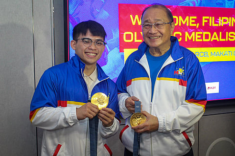 MANNY Pangilinan (right) lauds Carlos Yulo after making history with two gold medals in the Paris Olympics.