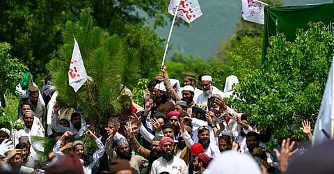 Supporters of Tehreek-e-Labbaik Pakistan (TLP) party gather near the capital's 'red zone,' to protest against Chief Justice Qazi Faez Isa over the court's ruling on the Ahmadiyya sect, in Islamabad on Aug. 22.
