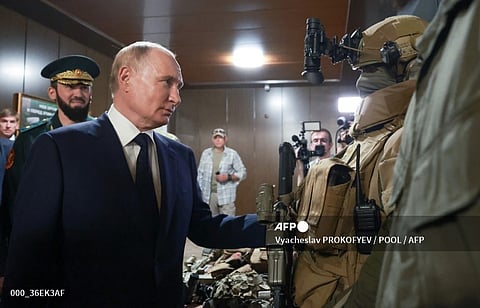 In this pool photograph distributed by Russian state owned Sputnik agency Russia's President Vladimir Putin (C-L) visits the "Russian Spetsnaz University" special force training centre in Gudermes on August 20, 2024.