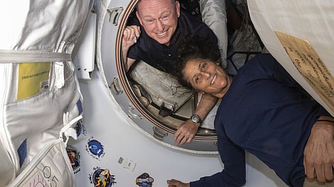 In this photo provided by NASA, Boeing Crew Flight Test astronauts Butch Wilmore, left, and Suni Williams pose for a portrait inside the vestibule between the forward port on the International Space Station's Harmony module and Boeing's Starliner spacecraft on 13 June 2024.