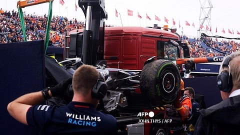 William's mechanics stand next to the crashed car of Williams' US driver Logan Sargeant during the third practice session at The Circuit Zandvoort, western Netherlands, on 24 August 2024, ahead of the Formula One Dutch Grand Prix. The Formula One Zandvoort Grand Prix race will take place on 25 August 2024.