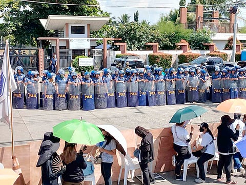 (FILES) Members of the Kingdom of Jesus Christ barricade CP Garcia Highway in Davao City in an effort to stop the police from arresting their leader, Pastor Apollo Quiboloy, believed to be holed up in their sprawling headquarters.