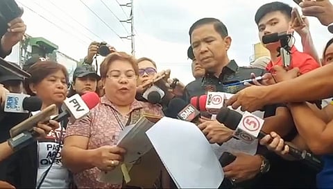 SHERIFF Teresita Ceballos of the Davao Regional Trial Court reads the court order on Tuesday, commanding the Philippine National Police 11 to halt any actions that endanger the life, liberty, or security of the petitioners and their property, as tensions rise over the ongoing standoff at the KoJC compound.