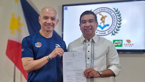FORMER Pampanga Rep. Joseller ‘Yeng’ Guiao and his lawyer, Atty. Avelino Guzman Jr., display a copy of the Supreme Court decision mandating Philippine Amusement and Gaming Corporation and Philippine Charity Sweepstakes Office to remit the full share of the Philippine Sports Commission in accordance to the law.