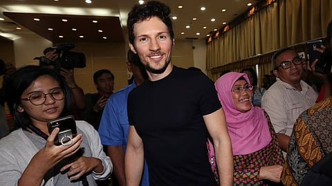 Telegram co-founder Pavel Durov, center, smiles as he leaves after a press conference following his meeting with Indonesian Communication and Information Minister Rudiantara in Jakarta, Indonesia, 1 Aug. 2017.