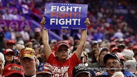 JOHNSTOWN, PENNSYLVANIA - AUGUST 30: Supporters listen to speeches during a campaign rally with Republican presidential nominee, former U.S. President Donald Trump in the 1st Summit Arena at the Cambria County War Memorial on August 30, 2024 in Johnstown, Pennsylvania. Promising to cut energy bills in half, conducting the largest deportation operation in history and putting a 200% tariff on foreign made automobiles, Trump called his election opponents "Comrade Kamala," and "Tampon Tim" while rallying in the all-important battleground state of Pennsylvania.