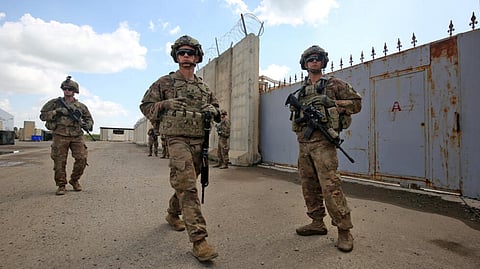US army soldiers, part of the Combined Joint Task Force Operation Inherent Resolve (CJTF-OIR), the US-led coalition against the Islamic State (IS) group, walk around at the K1 Air Base northwest of Kirkuk in northern Iraq before a planned US pullout on March 29, 2020.