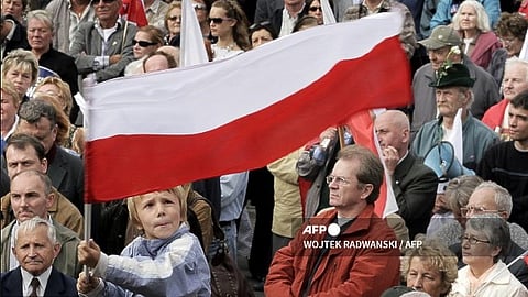 (FILES) A Polish boy waves a national flag as he takes part in a pro-government demonstration, 07 October 2006 in Warsaw.