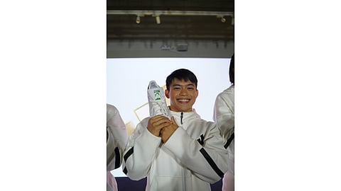 Carlos Yulo displays his customized Adidas Stan Smith shoe for competing in the Paris Olympics.