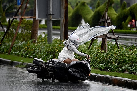 WOMAN riding a motorbike is blown down from the wind of typhoon ‘Yagi’ in Hai Phong city on 7 September 2024.