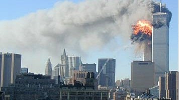 An image taken from the building that housed the National Archives at New York City office on 11 September 2001. The original caption reads: "From the roof of 201 Varick Street, just one floor up from NARA’s office, archivist John Celardo captured the moment a hijacked airliner crashed into the second tower."