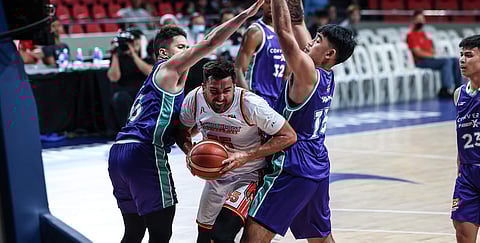 KEVIN Racal and Justin Arana of Converge make it difficult for NorthPort import Venky Jois to operate during their PBA Governors’ Cup game yesterday at the Ninoy Aquino Stadium. The FiberXers won, 107-99.