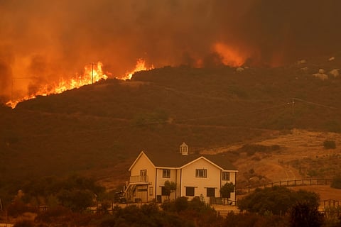 Los Angeles wildfire explodes, engulfing homes