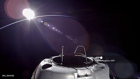 This handout picture courtesy of SpaceX and Polaris taken on September 12, 2024, shows an orbital sunset from the SpaceX Dragon capsule with a hatch structure called "Skywalker", ahead of the first private spacewalk performed by the crew of the SpaceX Polaris Dawn mission.