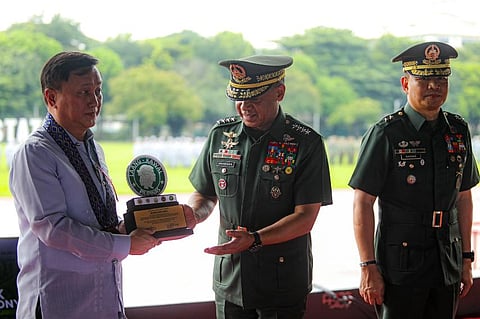 AFP Chief of Staff General Romeo Brawner Jr gives a memento to Senator Francis Tolentino during the culminating activity of the 45th National Reservist Week on 14 September in Camp Aguinaldo, Quezon City.