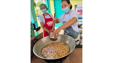 Members of the Gamot, Luya, Dalogo Farmers Association in Polangui, Albay cook pili nuts during their research and development training.