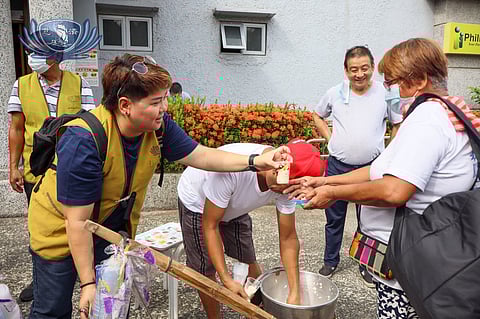 MARIE Salazar (left) personally serves taho to a patients of Tzu Chi Eye Center in Sta. Mesa, Manila on her birthday.