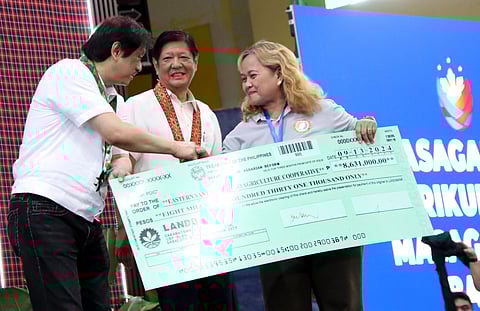 President Ferdinand R. Marcos Jr. and DAR Secretary Conrado M. Estrella III hand over agri-credit assistance check to twelve (12) ARB Organizations under Accessible Loans for Empowered, Resilient, and Transformed (ALERT) Program, credit assistance program offered by the Department of Agrarian Reform (DAR) thru the Land Bank of the Philippines (LBP) in Nueva Ecija Coliseum, Brgy. Singalat, Palayan City, Nueva Ecija.
