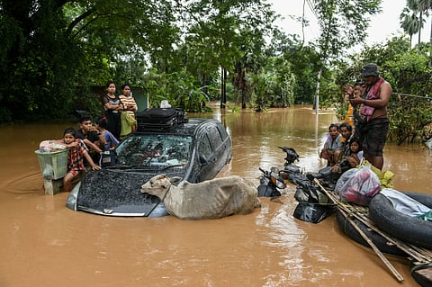 LOOK: Flood-affected residents wait for a rescue boat to arrive in Taungoo, Myanmar's Bago region on September 14, 2024, following heavy rains in the aftermath of Typhoon Yagi. Typhoon Yagi brought a colossal deluge of rain that has inundated a swathe of northern Vietnam, Laos, Thailand and Myanmar, triggering deadly landslides and widespread river flooding.| Photo courtesy of Sai Aung MAIN / AFP