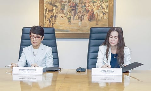 Once fully in place, the eWallet-Carded and eWallet-Virtual to be introduced by LandBank, in collaboration with digital service provider Traxion Pay Inc. are expected to improve government disbursements and advance financial inclusion. Photo shows LandBank president and CEO Lynette V. Ortiz (left) and Traxion Pay Inc. CEO Judy Cuisia, signing off on the two institutions’ technology partnership.