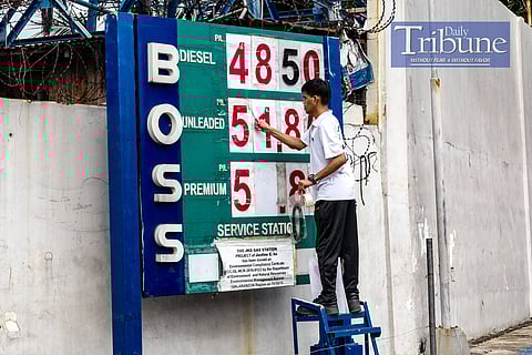A gas station attendant changes the prices displayed on September 17, 2024. Fuel prices will drop starting September 17, 2024, with reductions of at least P1 per liter for gasoline, P1.30 for diesel, and P1.65 for kerosene. This decrease is attributed to weak global demand and concerns about oversupply, particularly from China and the U.S. Recent data show that the year-to-date net increases for gasoline and diesel have been P5.85 and P3.05 per liter, respectively. The rollback follows similar price cuts from the previous week, driven by sluggish demand and plans from oil-producing nations to increase output. PHOTOS BY YUMMIE DINGDING