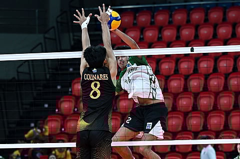 PAUL Colinares of UST tries to stop the attack of Eric Layug of La Salle during their V-League Men’s Collegiate Challenge on Wednesday at the PhilSports Arena. The Golden Spikers won, 22-25, 25-23, 25-15, 25-16.