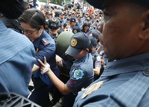 ALICE Guo, the dismissed mayor of Bamban, Tarlac, is escorted by the PNP to the Valenzuela Regional Trial Court Branch 282 yesterday even as arraignment has been moved to 30 September. Guo faces charges of graft and corruption during her term as mayor.