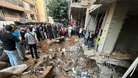 People check the damage at the scene of an Israeli strike in Beirut's southern suburbs on September 20, 2024.