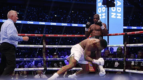 Anthony Joshua is knocked to the ground by Daniel Dubois during their IBF world title fight at Wembley