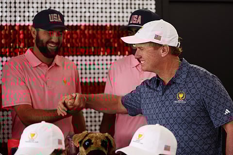 SCOTTIE Scheffler of the US Team bumps fists with Junior Presidents Cup US Team Captain Charlie Hoffman during team portraits prior to the 2024 Presidents Cup at The Royal Montreal Golf Club Thursday.