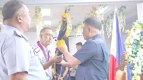 RETIRING Coast Guard spokesperson Rear Admiral Armand Balilo (left) hands the PCG flag to his chief, Admiral Ronnie Gil Gavan, as Commodore Teotimo Borja Jr. looks on.