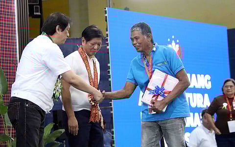 (FILE PHOTO) President Ferdinand R. Marcos Jr. and DAR Secretary Conrado M. Estrella III during the distribution of Certificates of Condonation with Release of Mortgage (COCROM) in Nueva Ecija.