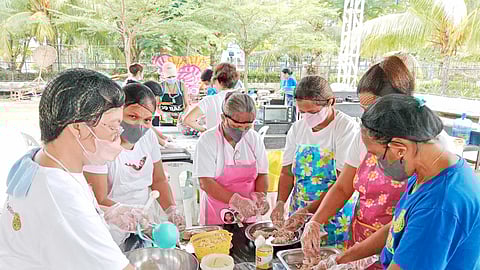 MEMBERS of the Sangit-sangit Fisherfolks Association make fish salad during a livelihood training program of BPI Foundation and Pilipinas Shell Foundation.