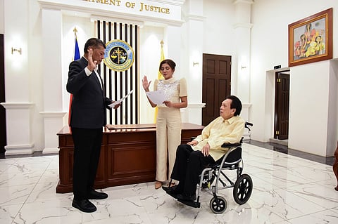 Department of Justice Secretary Jesus Crispin Remulla (left) administers the oath of office to Atty. Margaret Raizza Andaman after her appointment as Office for Alternative Dispute Resolution Executive Director V.