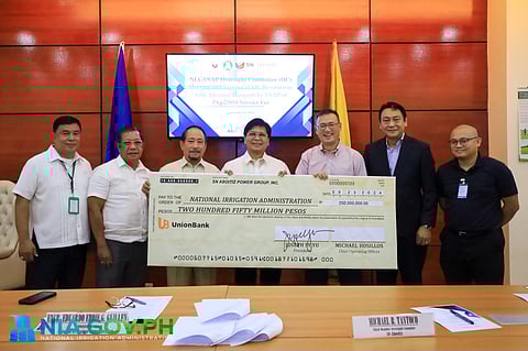 SN Aboitiz Power Group Inc. president and CEO Joseph S. Yu (3rd from left) turns over the symbolic check for P250 million to National Irrigation Administration chief Eduardo Eddie G. Guillen (center) in a ceremony last week.