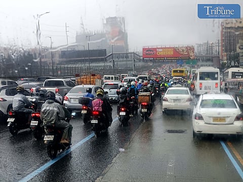 LOOK: Motorists drive through heavy downpours along the westbound lane of Commonwealth Avenue in Quezon City on Tuesday morning, 1 October 2024.