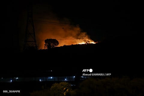 Fire erupts between Ben Gurion International Airport near Tel Aviv and the city of Modiin following an Iranian missile attack, on 1 October 2024.