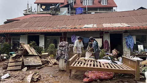 People clean up after major flooding in Kalaw township in Myanmar's southern Shan state on September 19, 2024, following heavy rains in the aftermath of Typhoon Yagi