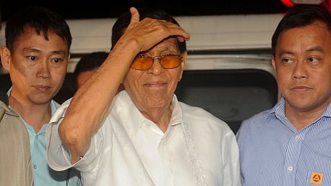 (FILES) Senator Juan Ponce Enrile (C), formerly a defense minister and once one of the Philippines' most powerful men, arrives at a special anti-graft court to file bail in suburban Manila on 20 August 2015.