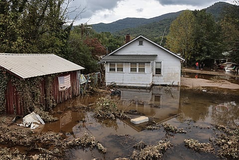 LOOK: SWANNANOA, NORTH CAROLINA - 4 OCTOBER: An American flag hangs above floodwaters remaining from Hurricane Helene on 4 October 2024 in Swannanoa, North Carolina. At least 215 people were killed in six states in the wake of the powerful hurricane which made landfall as a Category 4. President Joe Biden ordered the deployment of 1,000 active duty U.S. soldiers to assist with storm relief efforts in what is now the deadliest U.S. mainland hurricane since Hurricane Katrina. | Photo courtesy of Mario Tama/ via AFP