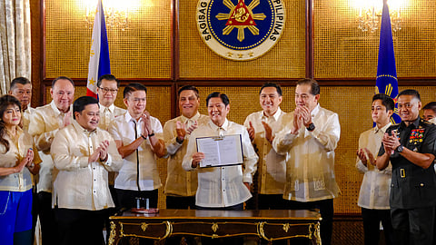 PRESIDENT Ferdinand Romualdez Marcos Jr. signs the Self-Reliant Defense Posture Revitalization Act on Tuesday at Malacañang Palace. In his speech during the ceremonial signing, he emphasized the act’s importance in enhancing the Philippines’ defense capabilities through local resources and innovation.