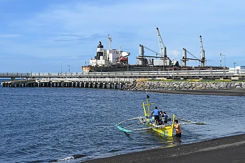 Boat departs from the shore near the South Luzon Thermal Energy Corporation power plant in the municipality of Calaca, Batangas, south of Manila. A few dozen kilometers from the Philippine capital Manila sits a coal plant that some hope could be a model for how developing countries can quit the polluting fossil fuel. An alliance led by The Rockefeller Foundation, a philanthropic group, plans to help close the plant 10 years early, avoiding millions of tons of emissions and monetizing them as carbon credits.