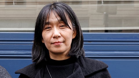 This photo taken on 9 November 2023 shows South Korean author Han Kang as she poses after co-winning (jointly with Portuguese author Lidia Jorge) the Medicis Prize for a foreign novel in Paris. South Korean author Han Kang won the Nobel Prize in Literature 2024, it was announced on 10 October 2024.